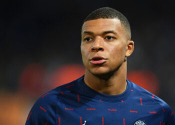 PARIS, FRANCE - OCTOBER 19: Kylian Mbappe of Paris Saint-Germain looks on as he warms up prior to the UEFA Champions League group A match between Paris Saint-Germain and RB Leipzig at Parc des Princes on October 19, 2021 in Paris, France. (Photo by Matthias Hangst/Getty Images)
