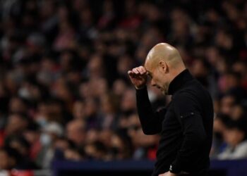 Manchester City's Spanish coach Josep Guardiola reacts during the UEFA Champions League quarter final second leg football match between Club Atletico de Madrid and Manchester City FC at the Wanda Metropolitano stadium in Madrid on April 13, 2022. (Photo by OSCAR DEL POZO / AFP) (Photo by OSCAR DEL POZO/AFP via Getty Images)