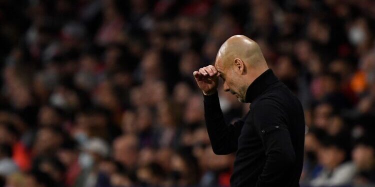 Manchester City's Spanish coach Josep Guardiola reacts during the UEFA Champions League quarter final second leg football match between Club Atletico de Madrid and Manchester City FC at the Wanda Metropolitano stadium in Madrid on April 13, 2022. (Photo by OSCAR DEL POZO / AFP) (Photo by OSCAR DEL POZO/AFP via Getty Images)