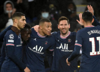 Paris Saint-Germain's Argentinian forward Lionel Messi (2nd R) is congratulated by team mates after scoring a goal during the UEFA Champions League first round day 6 Group A football match between Paris Saint-Germain (PSG) and Club Brugge, at the Parc des Princes stadium in Paris on December 7, 2021. (Photo by FRANCK FIFE / AFP) (Photo by FRANCK FIFE/AFP via Getty Images)