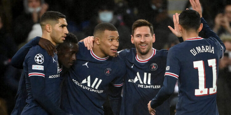 Paris Saint-Germain's Argentinian forward Lionel Messi (2nd R) is congratulated by team mates after scoring a goal during the UEFA Champions League first round day 6 Group A football match between Paris Saint-Germain (PSG) and Club Brugge, at the Parc des Princes stadium in Paris on December 7, 2021. (Photo by FRANCK FIFE / AFP) (Photo by FRANCK FIFE/AFP via Getty Images)