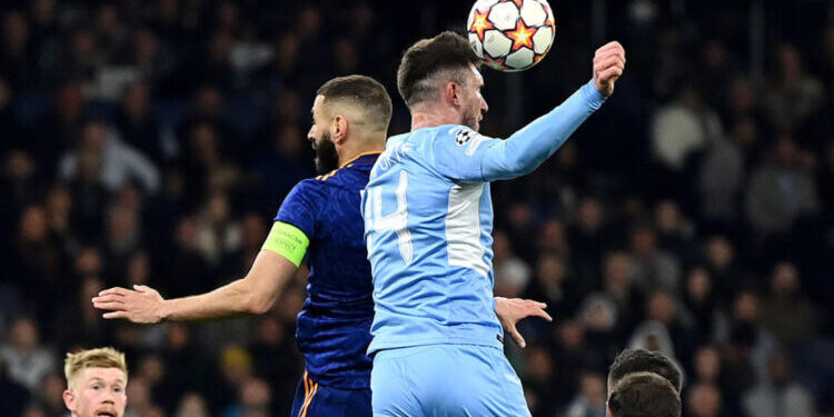 MANCHESTER, ENGLAND - APRIL 26: The ball strokes the hand of Aymeric Laporte of Manchester City leading to a penalty decision during the UEFA Champions League Semi Final Leg One match between Manchester City and Real Madrid at Etihad Stadium on April 26, 2022 in Manchester, England. (Photo by David Ramos/Getty Images)
