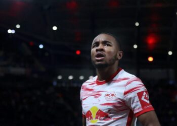 Leipzig's French midfielder Christopher Nkunku celebrates scoring the opening goal during the German first division Bundesliga football match between RB Leipzig and FC Cologne in Leipzig, eastern Germany on February 11, 2022. - DFL REGULATIONS PROHIBIT ANY USE OF PHOTOGRAPHS AS IMAGE SEQUENCES AND/OR QUASI-VIDEO (Photo by Ronny Hartmann / AFP) / DFL REGULATIONS PROHIBIT ANY USE OF PHOTOGRAPHS AS IMAGE SEQUENCES AND/OR QUASI-VIDEO (Photo by RONNY HARTMANN/AFP via Getty Images)