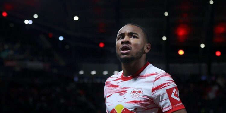 Leipzig's French midfielder Christopher Nkunku celebrates scoring the opening goal during the German first division Bundesliga football match between RB Leipzig and FC Cologne in Leipzig, eastern Germany on February 11, 2022. - DFL REGULATIONS PROHIBIT ANY USE OF PHOTOGRAPHS AS IMAGE SEQUENCES AND/OR QUASI-VIDEO (Photo by Ronny Hartmann / AFP) / DFL REGULATIONS PROHIBIT ANY USE OF PHOTOGRAPHS AS IMAGE SEQUENCES AND/OR QUASI-VIDEO (Photo by RONNY HARTMANN/AFP via Getty Images)
