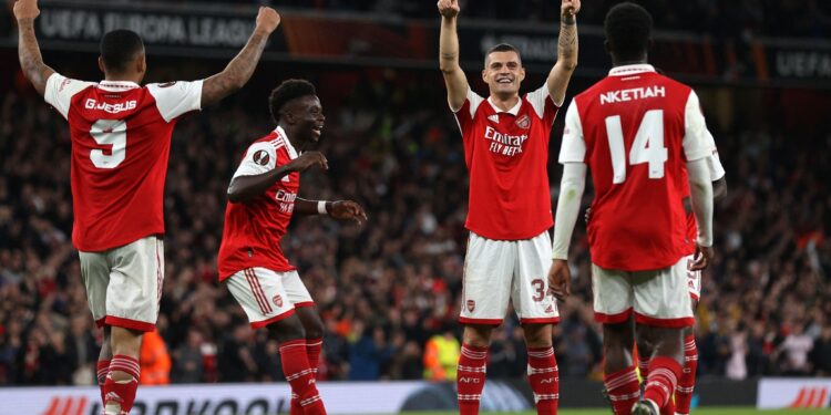 Arsenal's Swiss midfielder Granit Xhaka (2nd R) celebrates with teammates after scoring the opening goal of the UEFA Europa League Group A football match between Arsenal and PSV Eindhoven at The Arsenal Stadium in London, on October 20, 2022. (Photo by ADRIAN DENNIS / AFP) (Photo by ADRIAN DENNIS/AFP via Getty Images)