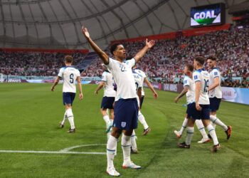 England's midfielder #22 Jude Bellingham (C) celebrates scoring his team's first goal during the Qatar 2022 World Cup Group B football match between England and Iran at the Khalifa International Stadium in Doha on November 21, 2022. (Photo by Adrian DENNIS / AFP) (Photo by ADRIAN DENNIS/AFP via Getty Images)