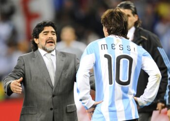Argentina's coach Diego Maradona (L) looks dejected in front of Argentina's striker Lionel Messi after they lost the 2010 World Cup quarter-final football match Argentina vs. Germany on July 3, 2010 at Green Point stadium in Cape Town. Germany qualified for the semi-finals.  NO PUSH TO MOBILE / MOBILE USE SOLELY WITHIN EDITORIAL ARTICLE -    AFP PHOTO / DANIEL GARCIA (Photo credit should read DANIEL GARCIA/AFP via Getty Images)