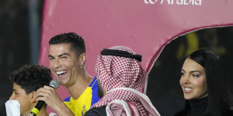 Cristiano Ronaldo and Georgina Rodriguez attend the official unveiling as a new member of Al Nassr soccer club in in Riyadh, Saudi Arabia, Tuesday, Jan. 3, 2023. Ronaldo, who has won five Ballon d'Ors awards for the best soccer player in the world and five Champions League titles, will play outside of Europe for the first time in his storied career. (AP Photo/Amr Nabil)