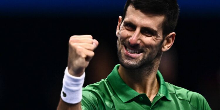 TOPSHOT - Serbia's Novak Djokovic celebrates after winning his first round-robin match against Greece's Stefanos Tsitsipas at the ATP Finals tennis tournament on November 14, 2022 in Turin. (Photo by Marco BERTORELLO / AFP)