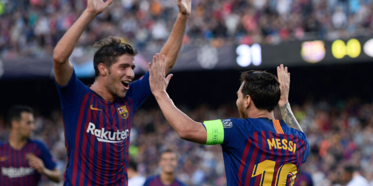 Barcelona's Argentinian forward Lionel Messi (R) celebrates with Barcelona's Spanish midfielder Sergi Roberto after scoring during the UEFA Champions' League group B football match FC Barcelona against PSV Eindhoven at the Camp Nou stadium in Barcelona on September 18, 2018. (Photo by Josep LAGO / AFP)        (Photo credit should read JOSEP LAGO/AFP via Getty Images)