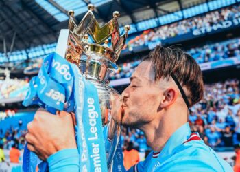 MANCHESTER, ENGLAND - MAY 21: Jack Grealish of Manchester City kisses the Premier League Trophy following the Premier League match between Manchester City and Chelsea FC at Etihad Stadium on May 21, 2023 in Manchester, England. (Photo by Michael Regan/Getty Images)