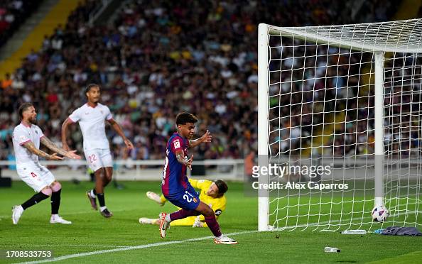 BARCELONA, SPAIN - SEPTEMBER 29: Lamine Yamal of Barcelona celebrates as Sergio Ramos of Sevilla scores an own-goal during the LaLiga EA Sports match between FC Barcelona and Sevilla FC at Estadi Olimpic Lluis Companys on September 29, 2023 in Barcelona, Spain. (Photo by Alex Caparros/Getty Images)