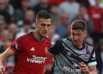 MANCHESTER, ENGLAND - OCTOBER 07: Diogo Dalot of Manchester United in action with Vitaly Janelt of Brentford during the Premier League match between Manchester United and Brentford FC at Old Trafford on October 07, 2023 in Manchester, England. (Photo by Matthew Peters/Manchester United via Getty Images)
