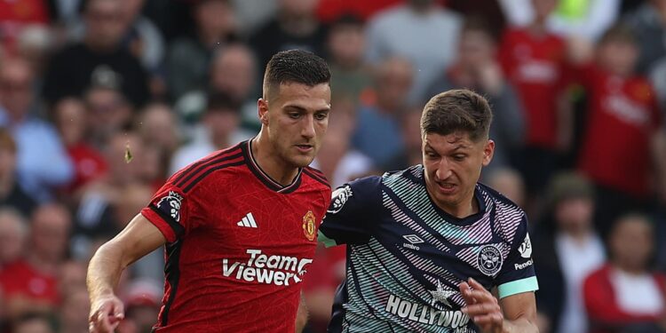 MANCHESTER, ENGLAND - OCTOBER 07: Diogo Dalot of Manchester United in action with Vitaly Janelt of Brentford during the Premier League match between Manchester United and Brentford FC at Old Trafford on October 07, 2023 in Manchester, England. (Photo by Matthew Peters/Manchester United via Getty Images)