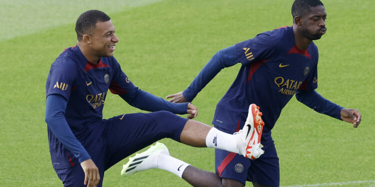 Soccer Football - Paris St Germain Training - Paris-Saint-Germain Training Centre, Poissy, France - August 18, 2023 Paris St Germain's Kylian Mbappe with Ousmane Dembele during training REUTERS/Christian Hartmann