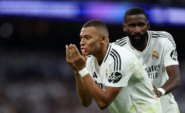 MADRID, SPAIN - SEPTEMBER 17: Kylian Mbappe  (L) of Real Madrid CF celebrates scoring their opening goal with teammate Antonio Rudiger (R) during the UEFA Champions League 2024/25 League Phase MD1 match between Real Madrid C.F. and VfB Stuttgart at Estadio Santiago Bernabeu on September 17, 2024 in Madrid, Spain. (Photo by Gonzalo Arroyo - UEFA/UEFA via Getty Images)