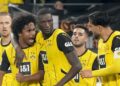 Dortmund's Serhou Yadaly Guirassi, center, celebrates with Karim Adeyemi, 2nd left, and Emre Can, right, after scoring his side's third goal during the German Bundesliga soccer match between Borussia Dortmund and VfL Bochum at Westfalenstadion in Dortmund, Germany, Friday, Sept. 27, 2024. (AP PhotoMartin Meissner)