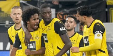 Dortmund's Serhou Yadaly Guirassi, center, celebrates with Karim Adeyemi, 2nd left, and Emre Can, right, after scoring his side's third goal during the German Bundesliga soccer match between Borussia Dortmund and VfL Bochum at Westfalenstadion in Dortmund, Germany, Friday, Sept. 27, 2024. (AP PhotoMartin Meissner)