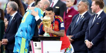 EAST RUTHERFORD, NEW JERSEY - JULY 19: Pedro Porro #12 of Spain kisses the FIFA World Cup Winner's Trophy as he receives the medal following the FIFA World Cup 2026 Final match between Spain and Argentina at New York New Jersey Stadium on July 19, 2026 in East Rutherford, New Jersey. (Photo by Dan Mullan/Getty Images)